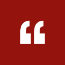 A red square with a white quotation mark symbol in the center.